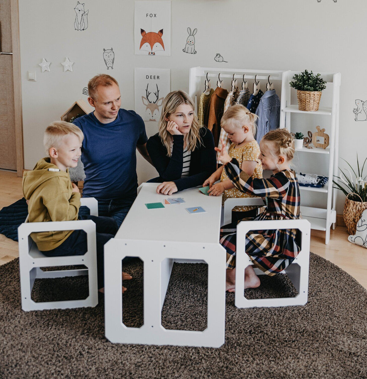 6. Family of five using white Montessori weaning table and chair set in cozy living room