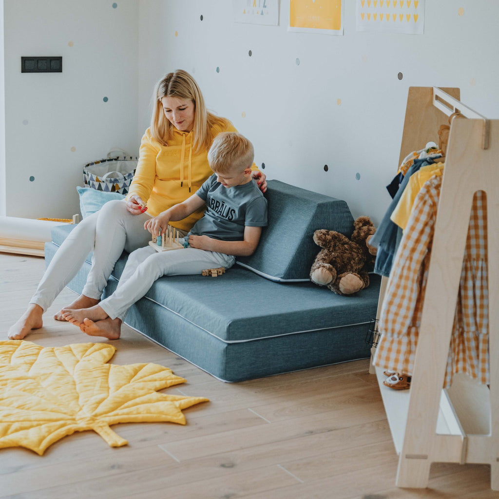 6. Woman and child sitting on turquoise Monboxy play mattress sofa in a cozy children's room