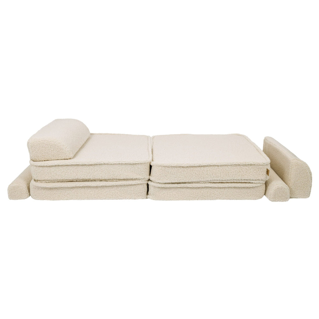 4. Cream modular sofa laid flat with backrest and armrest, demonstrating versatility in a studio setting