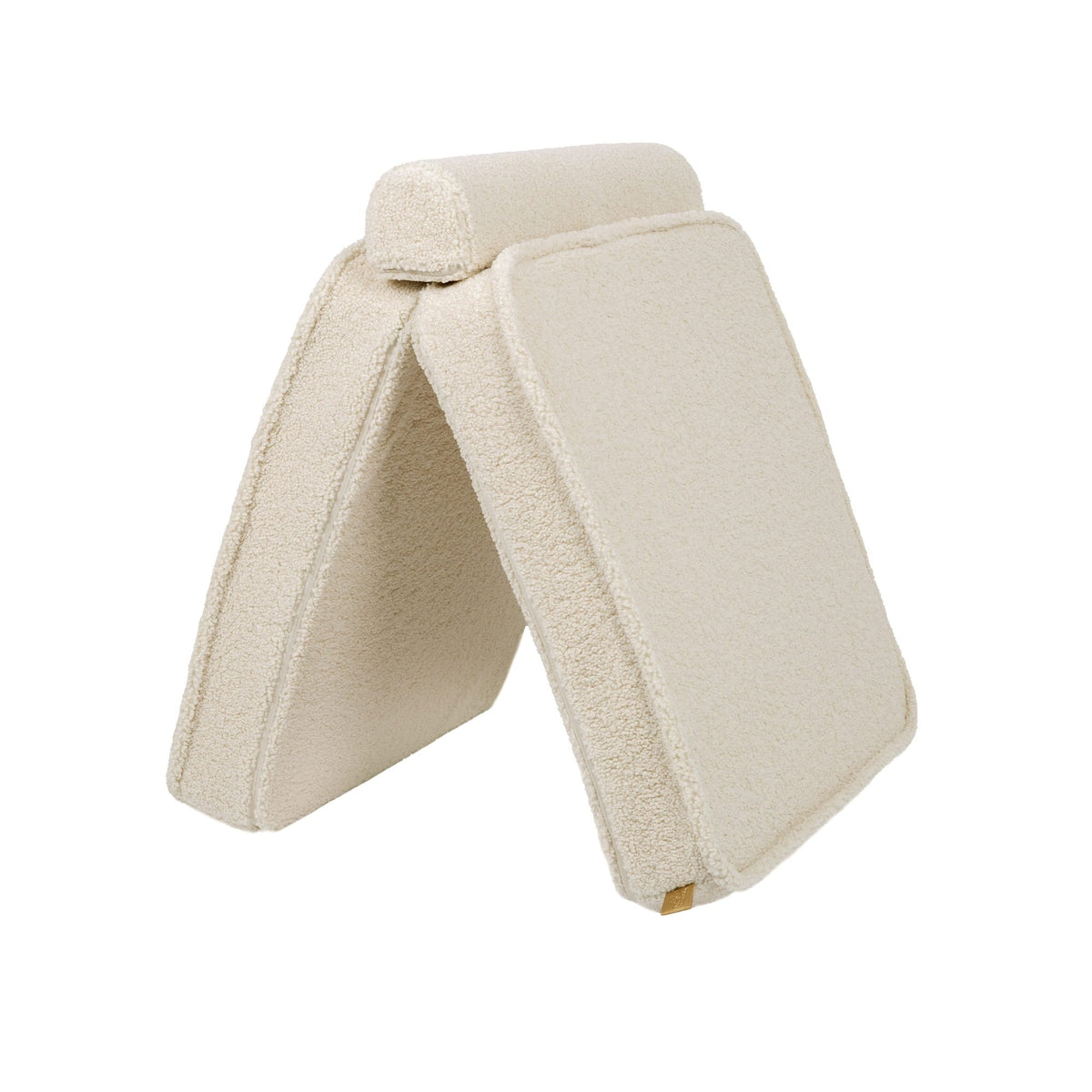 3. Cream sofa cushions arranged in a tent-like structure, highlighting versatility in a studio setting