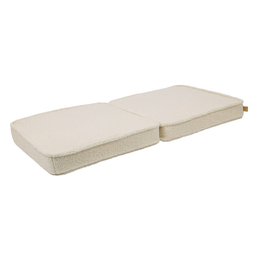 2. Cream sofa cushions laid flat, showcasing the modular design in a studio setting
