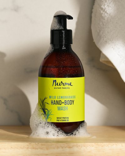 6. Nurme Wild Lemongrass Hand and Body Wash bottle with foam in a bathroom setting
