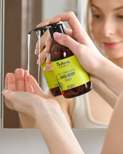 3. Woman dispensing Nurme Wild Lemongrass Hand and Body Wash in bathroom setting
