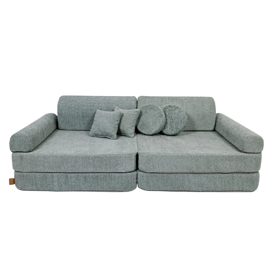 2. Large modular children's sofa in fresh mint boucle fabric with two square and one round cushion, shown in a studio setting