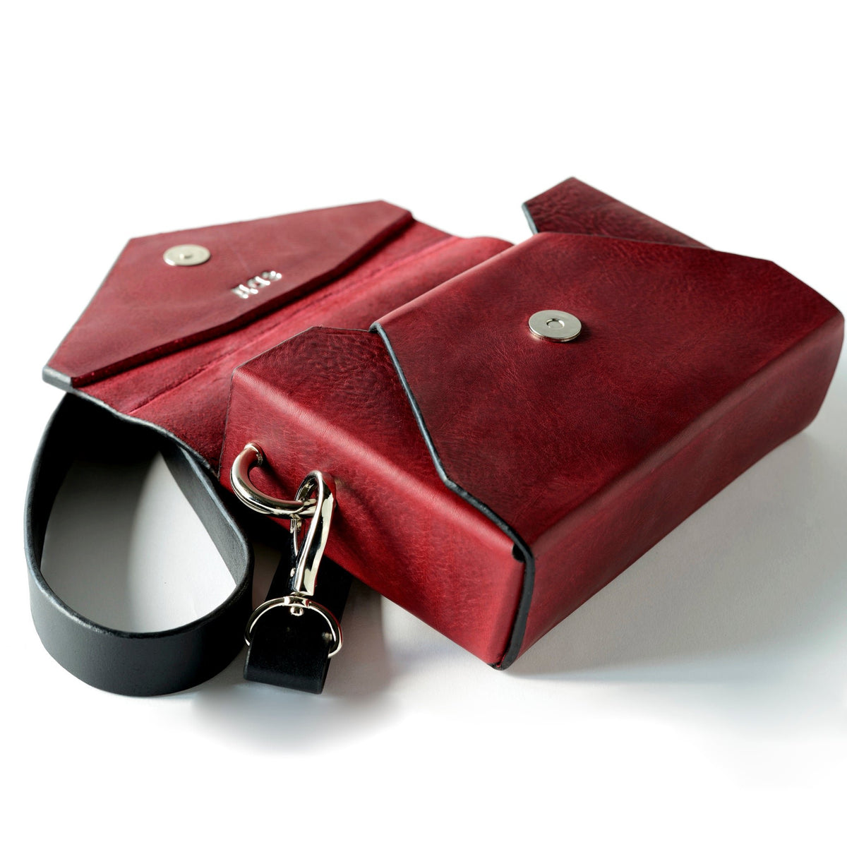 9. Open view of Daz Studio burgundy leather envelope bag showing raw leather interior and silver magnet closure