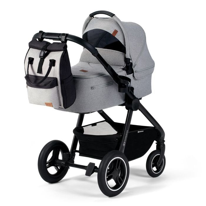 1. Grey Kinderkraft Moonpack diaper backpack attached to stroller in urban setting