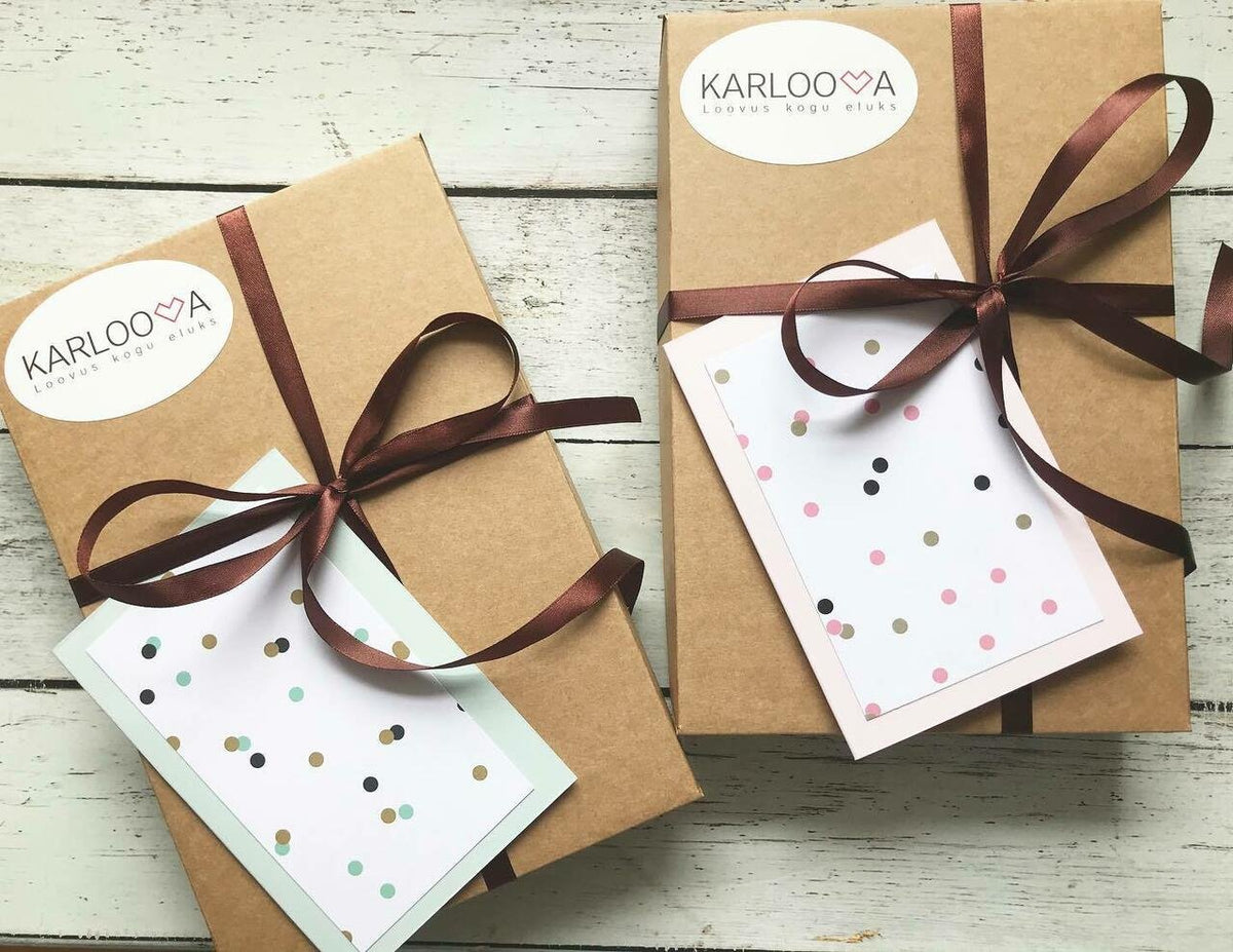 2. Two Karloova gift boxes with brown ribbon and polka dot cards on wooden surface