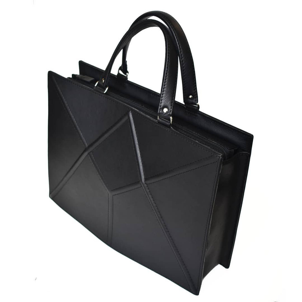 2. Side view of Gerda Retter Design FACET black handbag, highlighting structured design and handles