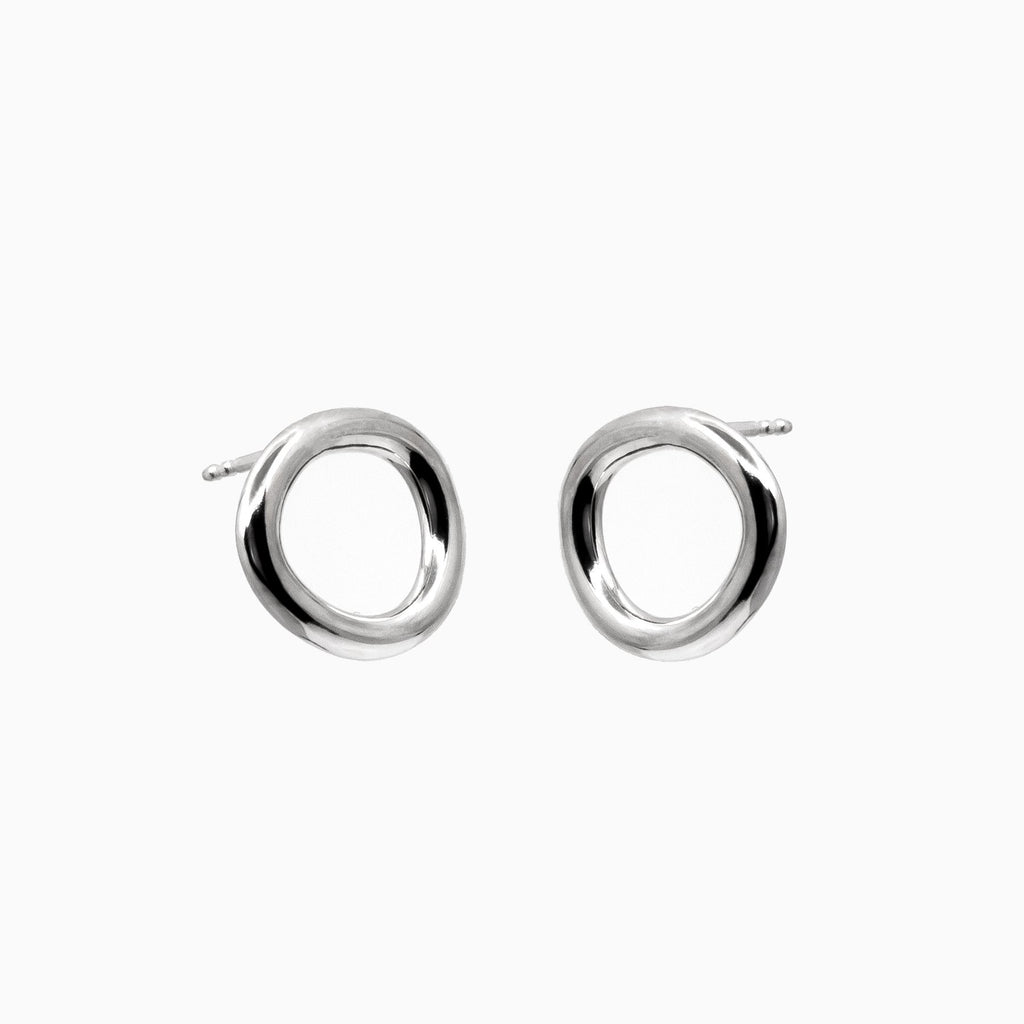 2. Studio image of Maarja Palu Earrings IRREGULAR x1 in polished silver with unique asymmetrical circular design