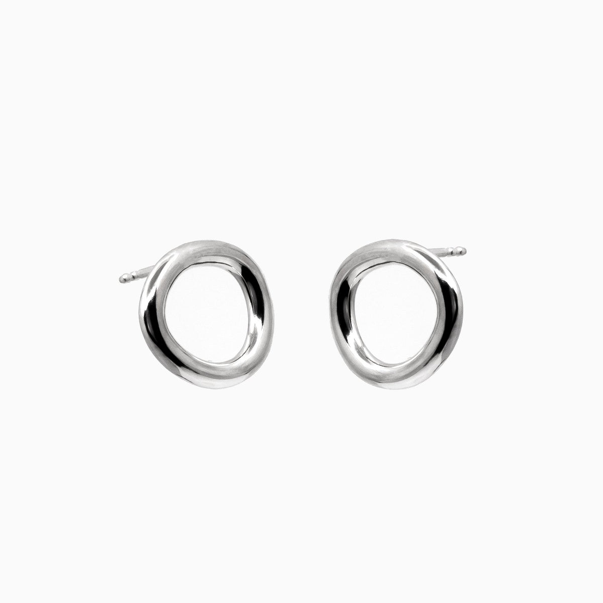 2. Studio image of Maarja Palu Earrings IRREGULAR x1 in polished silver with unique asymmetrical circular design
