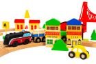 3. Close-up of wooden train set with colorful buildings and yellow car