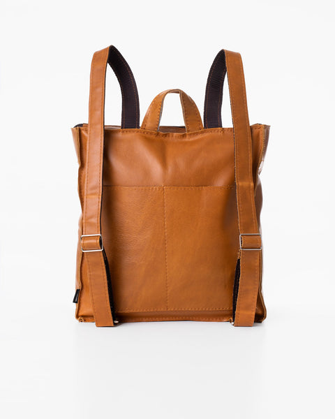 1. Trendbag Folk 2 Leather Backpack in caramel, shown from the back with adjustable straps, studio setting