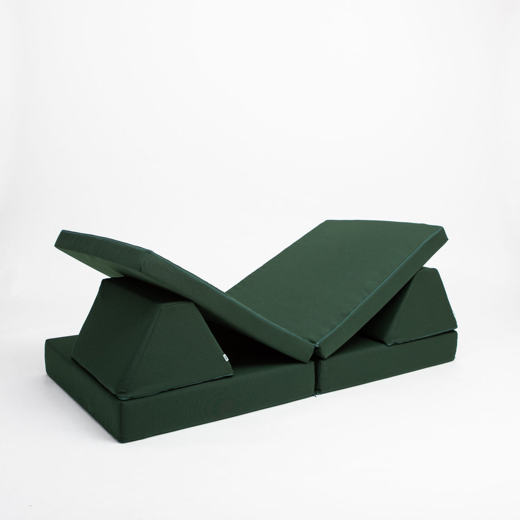 4. Monboxy deep green play mattress set in a reclined position with trapezoidal pillows