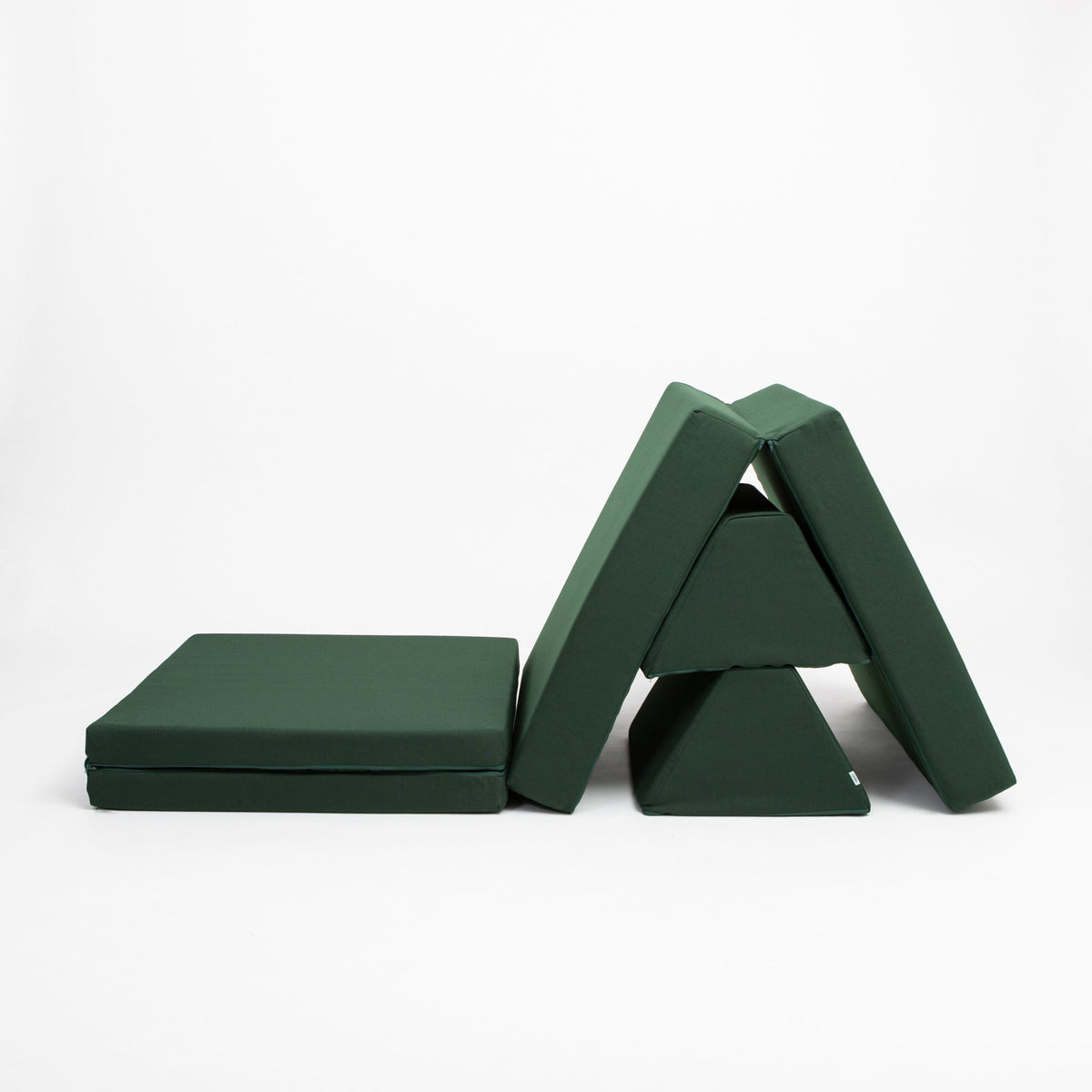 4. Monboxy deep green play mattress set arranged in a triangular structure on a white background