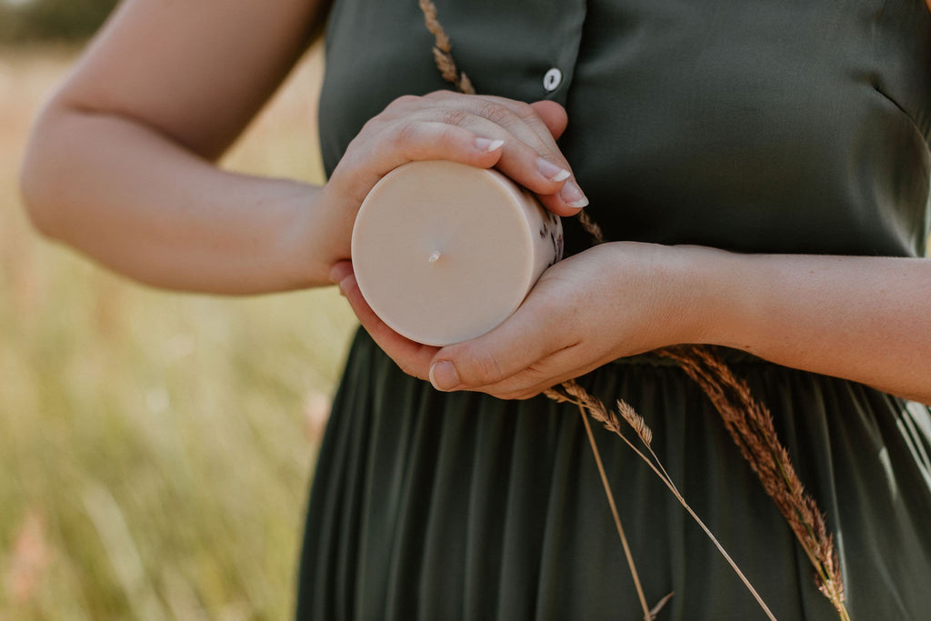 1. Hand-made soy wax candle with amber pieces, linden flower, and honey scent by TL Candles, displayed on a rustic table setting