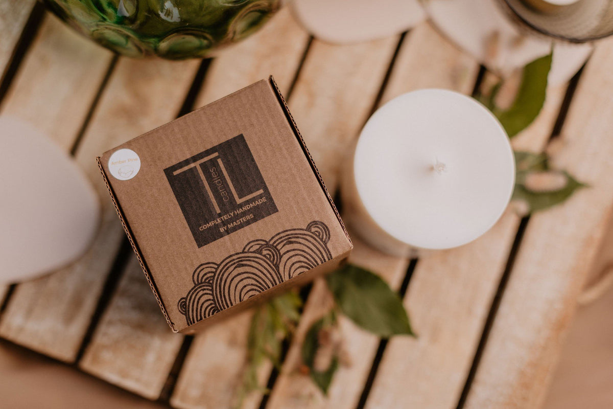 4. TL Candles packaging and soy wax candle on wooden surface, emphasizing hand-made quality and pine scent