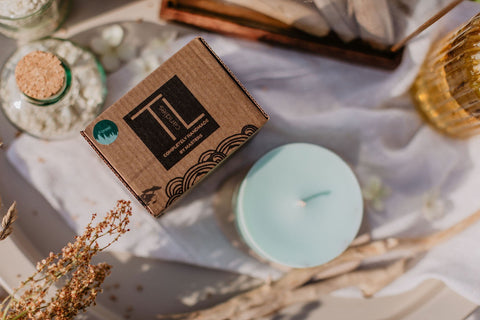 2. TL Candles packaging with mint green soy wax candle, styled with natural elements