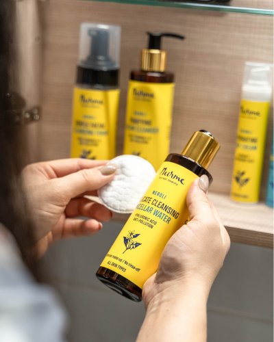 1. Nurme Gentle Cleansing Neroli Micellar Water bottle in a bathroom setting with cotton pad