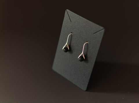 4. Studio shot of Canary Lava 14K gold-plated diffuser earrings with black lava beads on display card