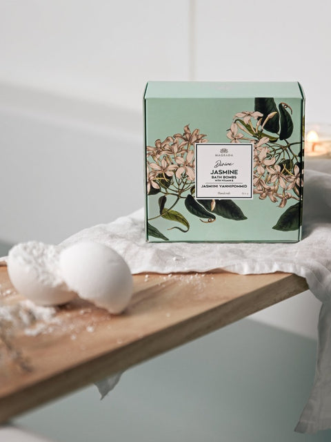 1. Lifestyle image of Magrada Organic Cosmetics Divine Jasmine Bath Bomb set with box and bath bomb on wooden board near bathtub