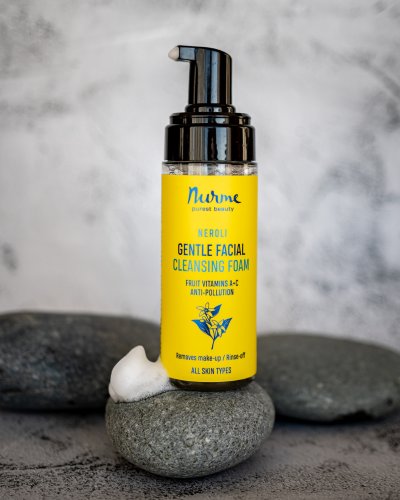 4. Nurme Gentle Neroli Cleansing Foam bottle on stones, emphasizing natural ingredients and skincare benefits