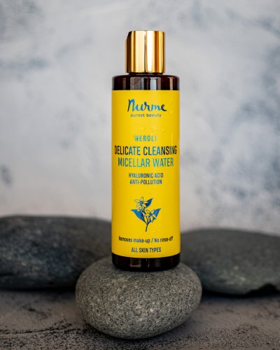 2. Nurme Gentle Cleansing Neroli Micellar Water bottle on stones, highlighting natural ingredients