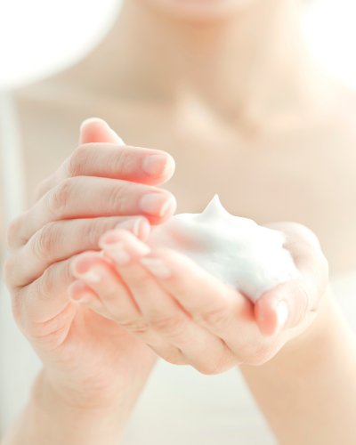 4. Close-up of Nurme Rose Face Cleansing Foam in hand, showing creamy texture