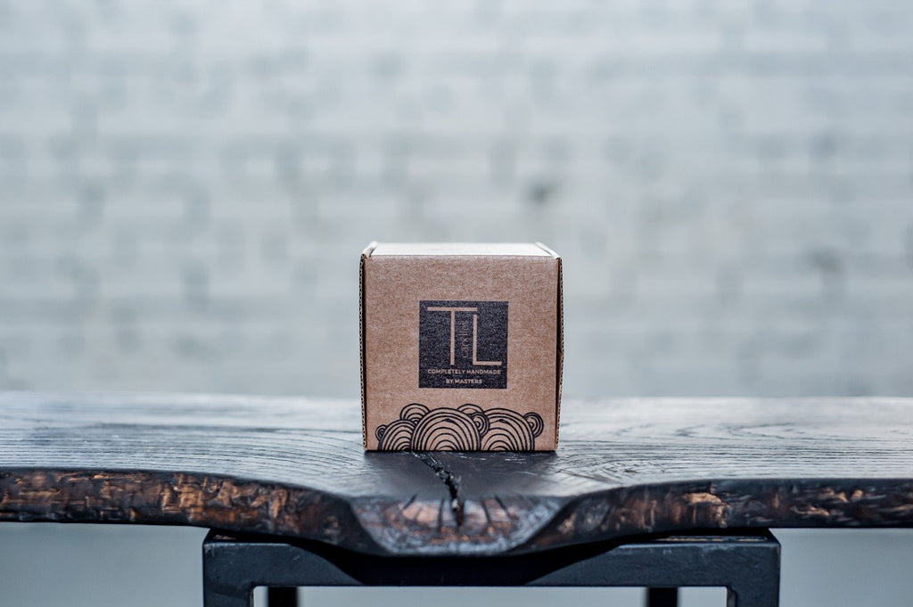 7. TL Candles branded packaging box on a wooden surface, showcasing elegant design
