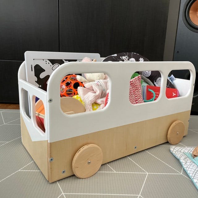 2. Ewart Woods kids toy storage box bus filled with colorful toys on a patterned floor