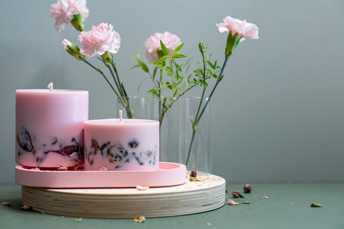 4. Pair of hand-made soy wax candles with peony scent by TL Candles, displayed with floral arrangement