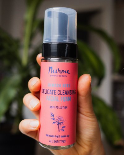 3. Close-up of Nurme Rose Face Cleansing Foam bottle held by a hand, emphasizing product design