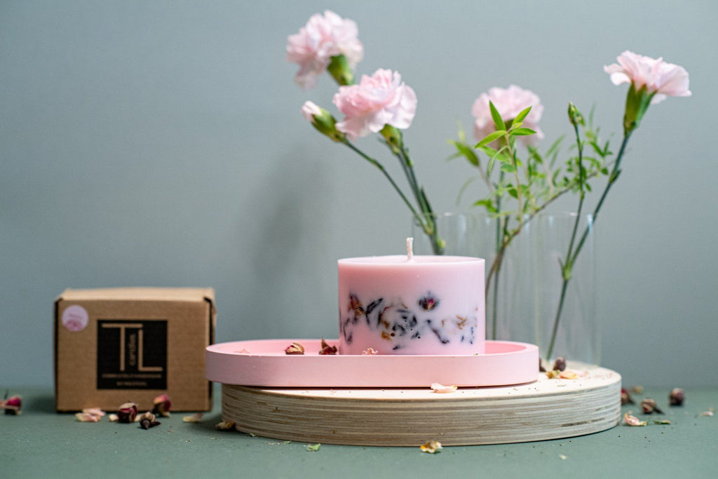 6. Small hand-made soy wax candle with peony scent by TL Candles, displayed with packaging and flower petals