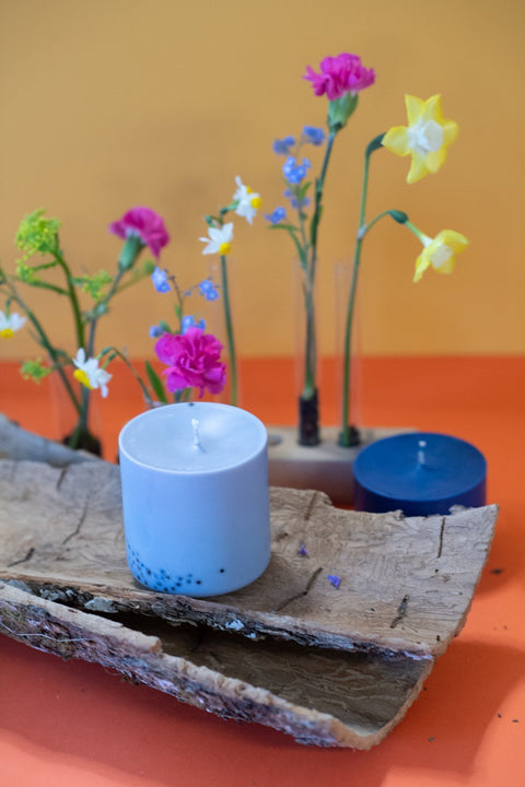 4. TL Candles hand-made soy wax candle with patchouli scent, styled with colorful flowers on a wooden surface