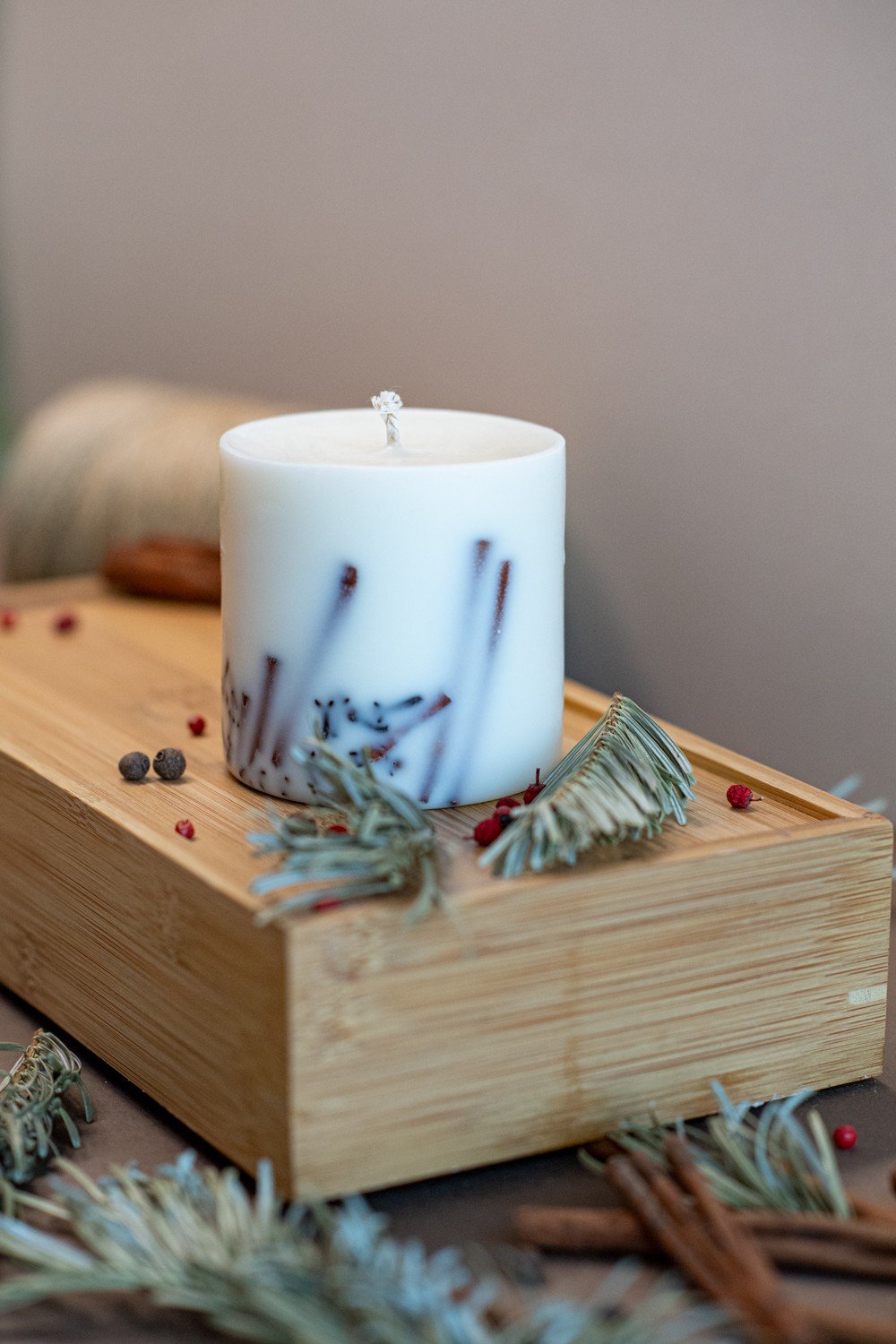 2. White soy wax candle with lavender decoration on wooden tray, surrounded by spices and herbs