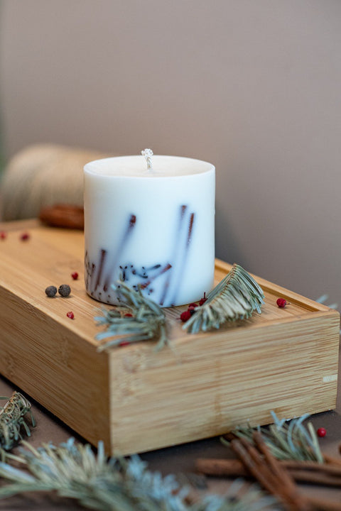 2. White soy wax candle with lavender decoration on wooden tray, surrounded by spices and herbs