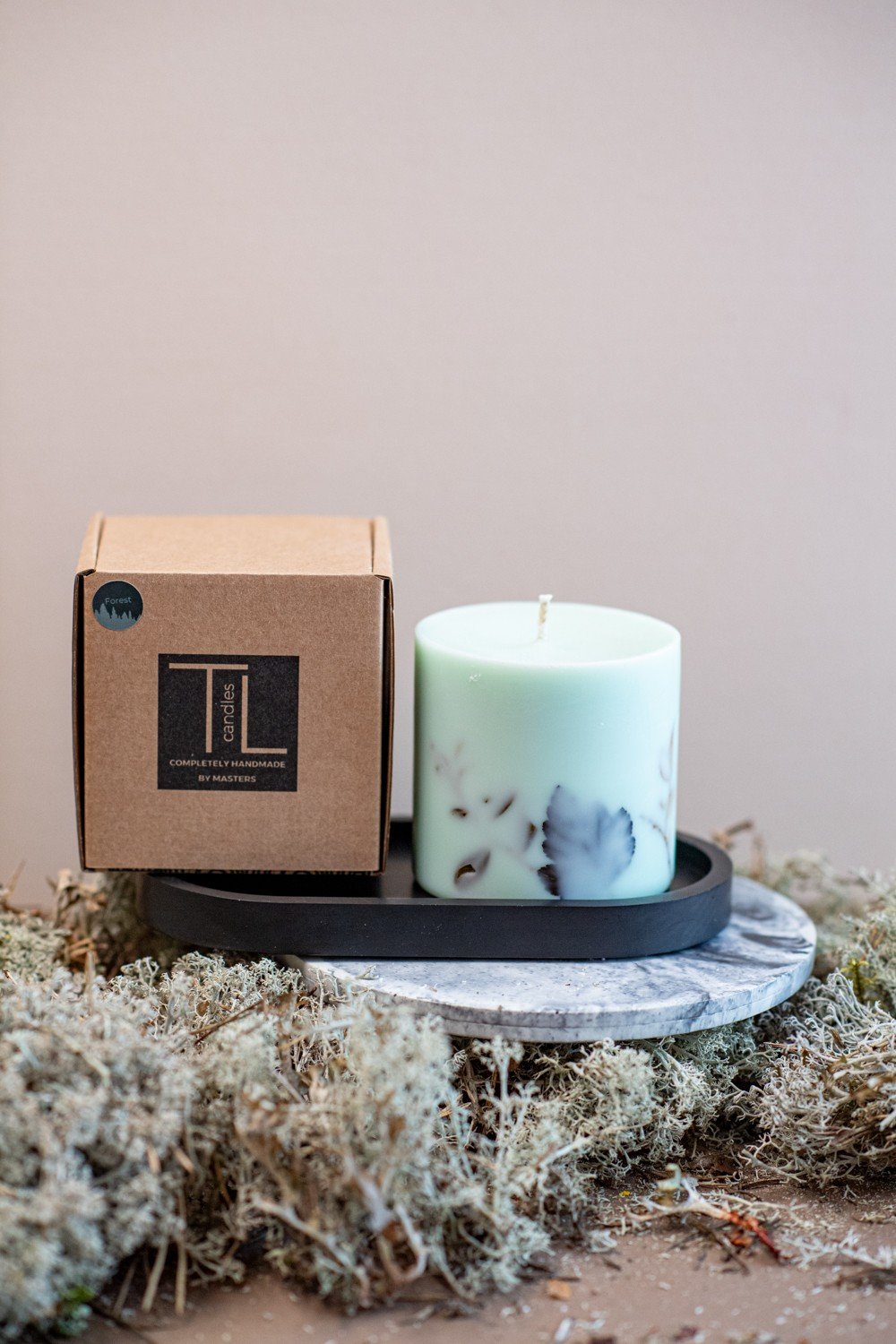6. Mint green soy wax candle with forest scent and TL Candles box, styled with natural moss