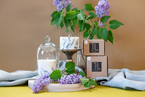 2. TL Candles hand-made soy wax candle with lavender scent, shown with packaging and lavender blossoms, lifestyle setting