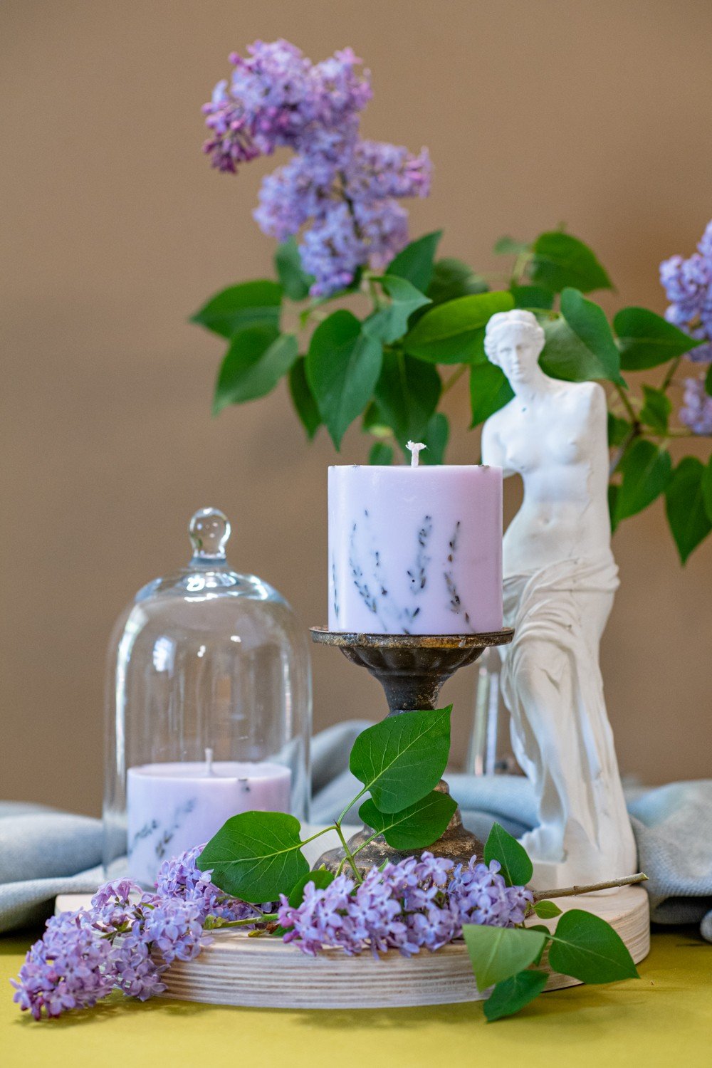 1. Hand-made purple soy wax candle with lavender scent by TL Candles, styled with lavender blossoms and decorative statue