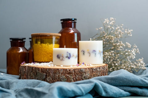 1. Hand-made unscented soy wax candles with dried flowers by TL Candles, displayed on a wooden slab with decorative jars in a lifestyle setting