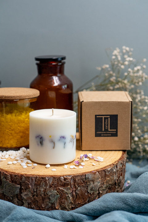 2. Hand-made unscented soy wax candle with dried flowers by TL Candles, shown with branded packaging on a wooden slab