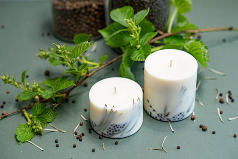 3. Pair of TL Candles hand-made soy wax candles with juniper scent, styled with fresh greenery