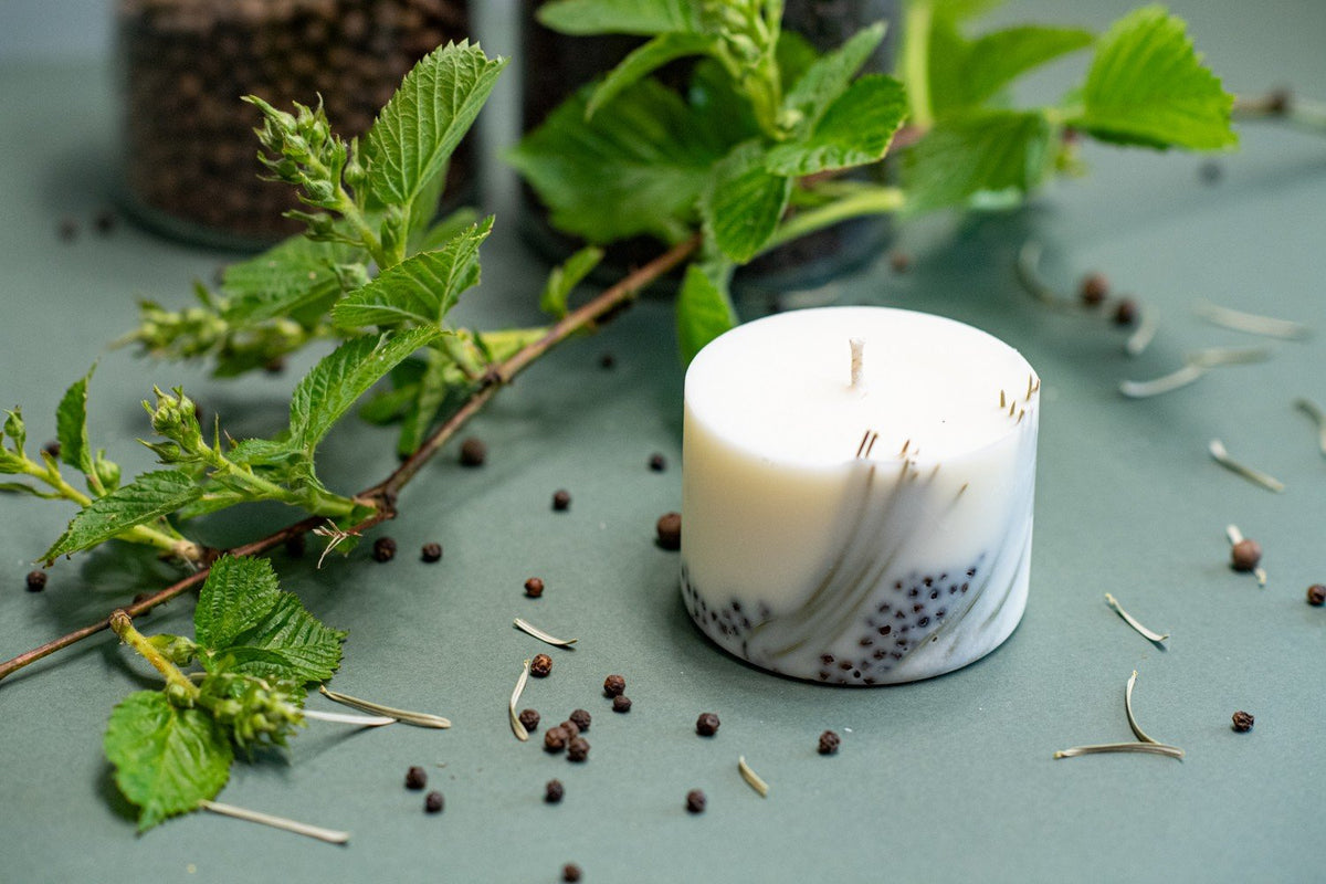 1. Hand-made soy wax candle with juniper scent, decorated with pine needles and berries, styled with fresh greenery