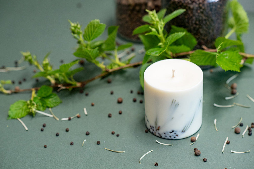 5. TL Candles hand-made soy wax candle with juniper fragrance, styled with fresh greenery and pine needles