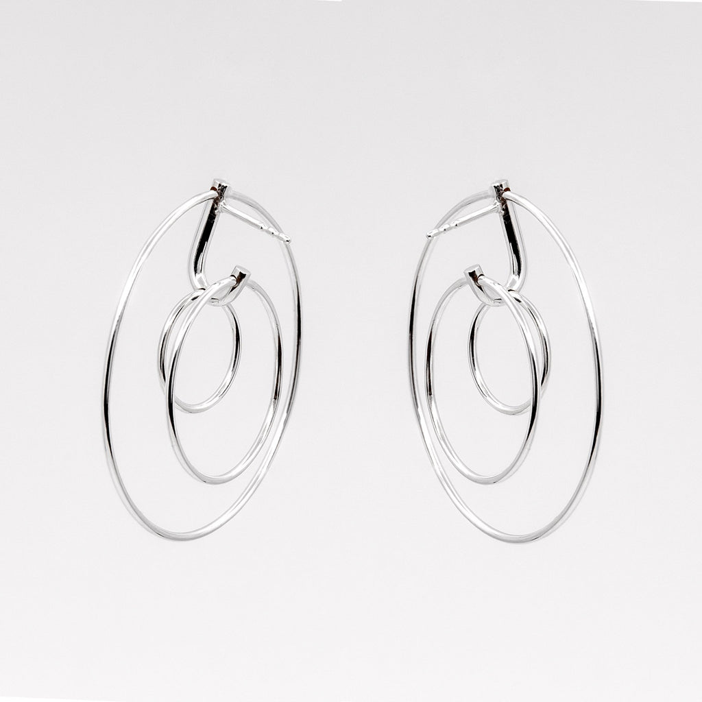 2. Studio image of Maarja Palu LAYERS x3 earrings featuring three interlocking silver circles