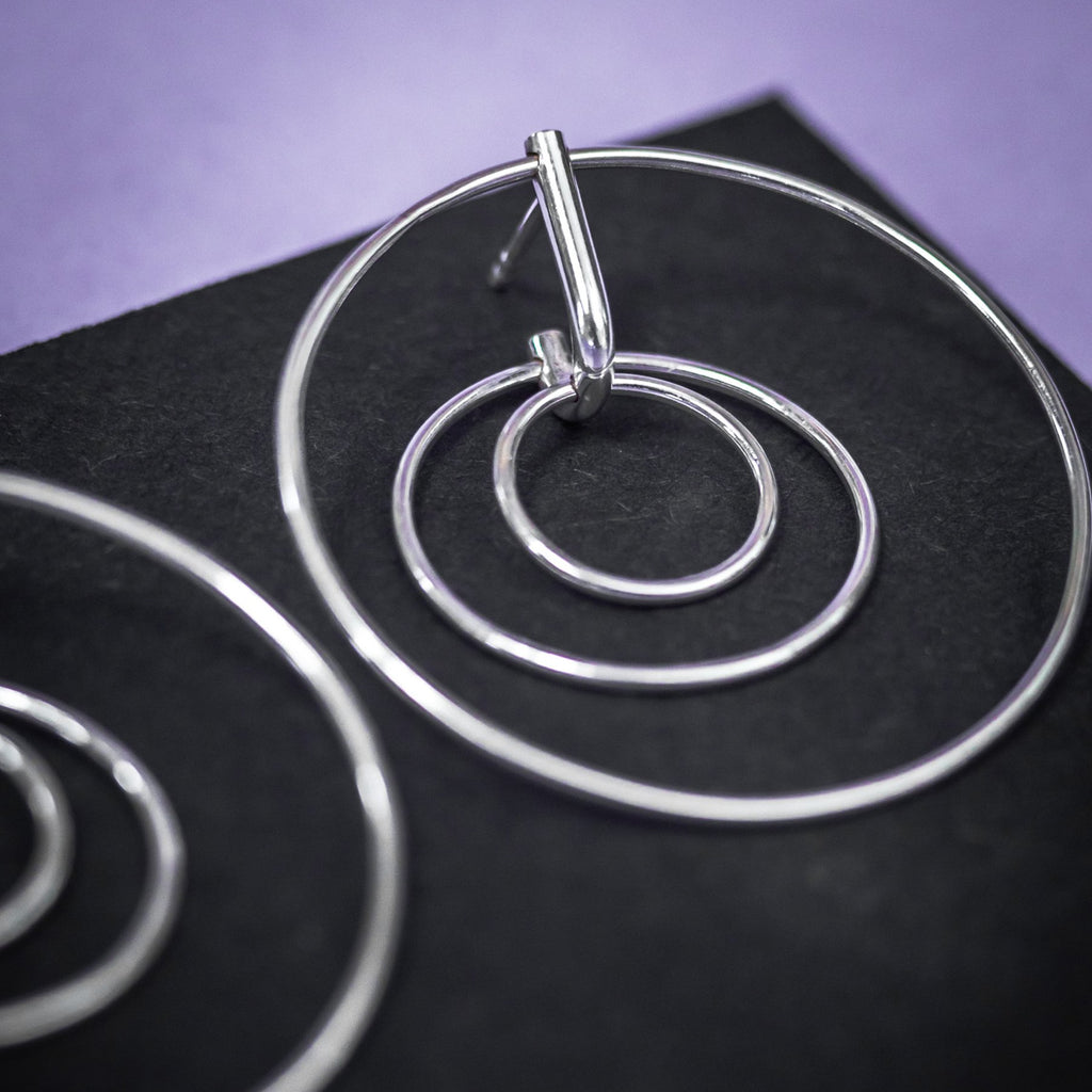 3. Close-up of Maarja Palu LAYERS x3 silver earrings highlighting interlocking circle design
