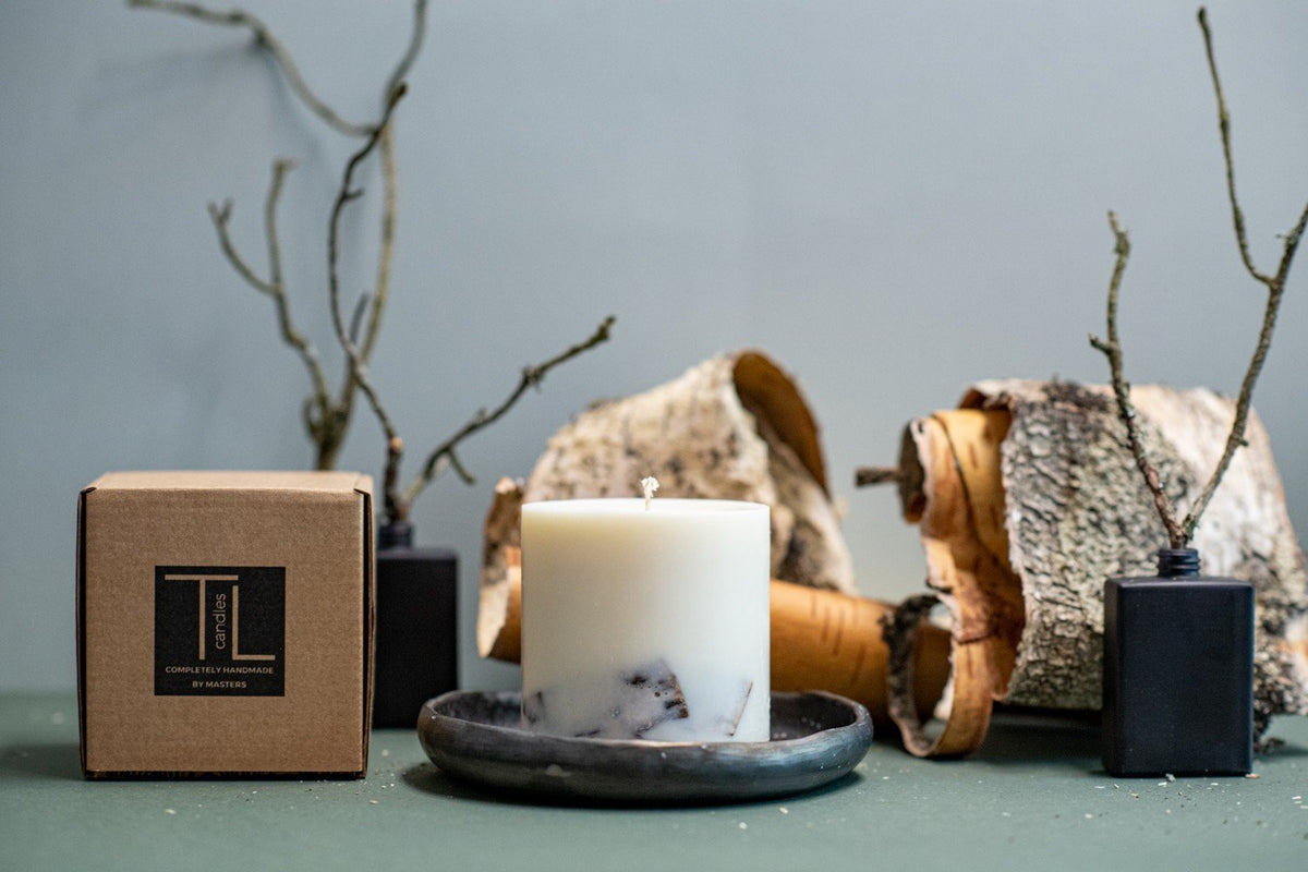 2. TL Candles hand-made soy wax candle with birch scent, shown with branded packaging and birch bark