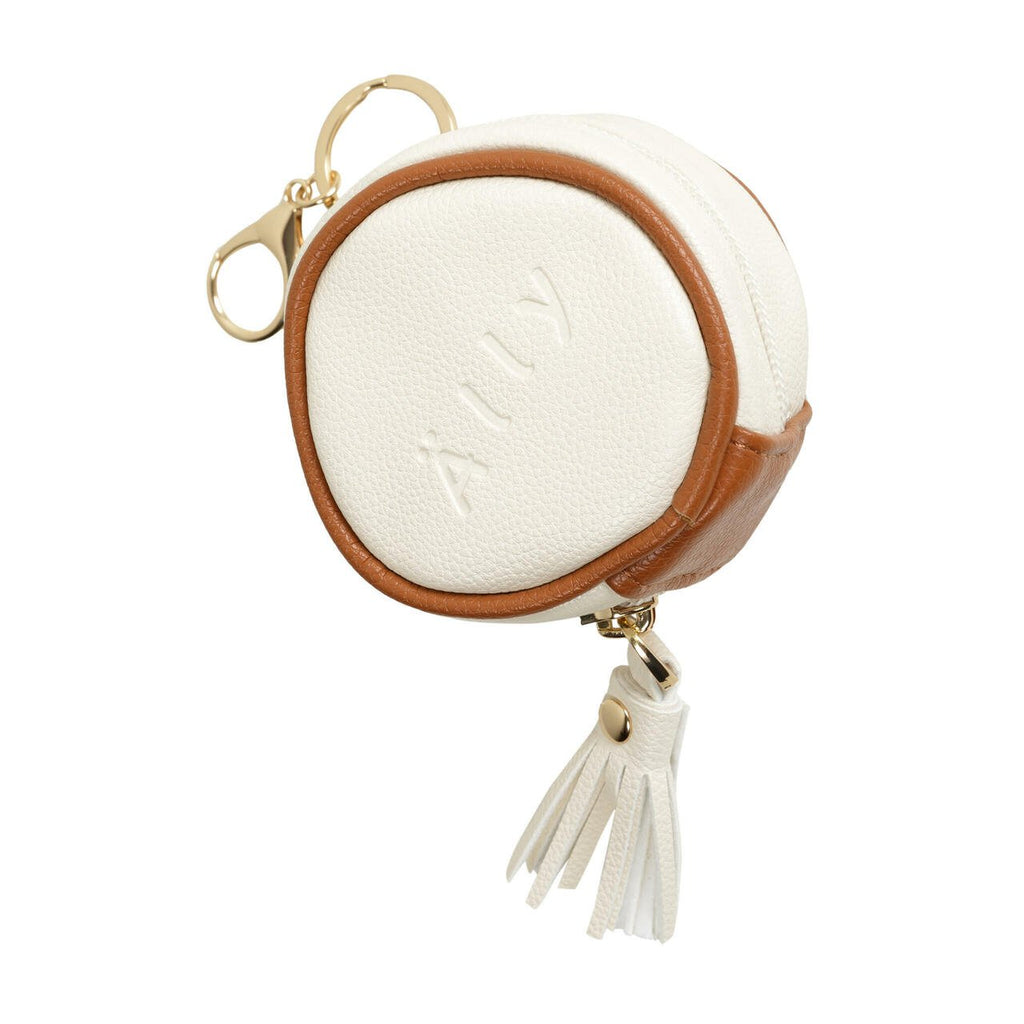 2. Studio shot of Ally Scandic white pacifier bag with brown trim and tassel detail