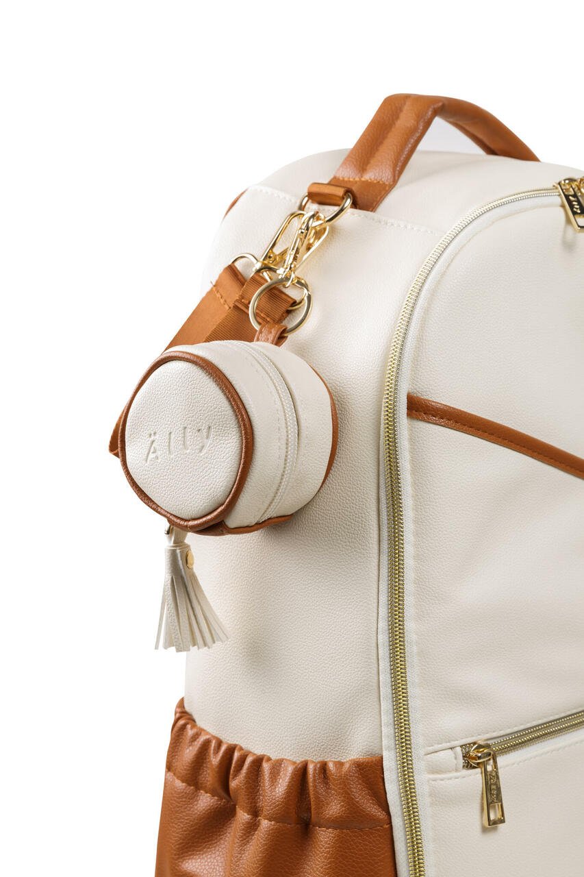 1. Ally Scandic white pacifier bag attached to a matching bag, showcasing its practical clip design