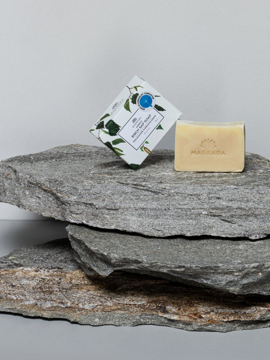 2. Magrada Nordic Birch Sap Soap with packaging on stone, highlighting organic certification and brand logo