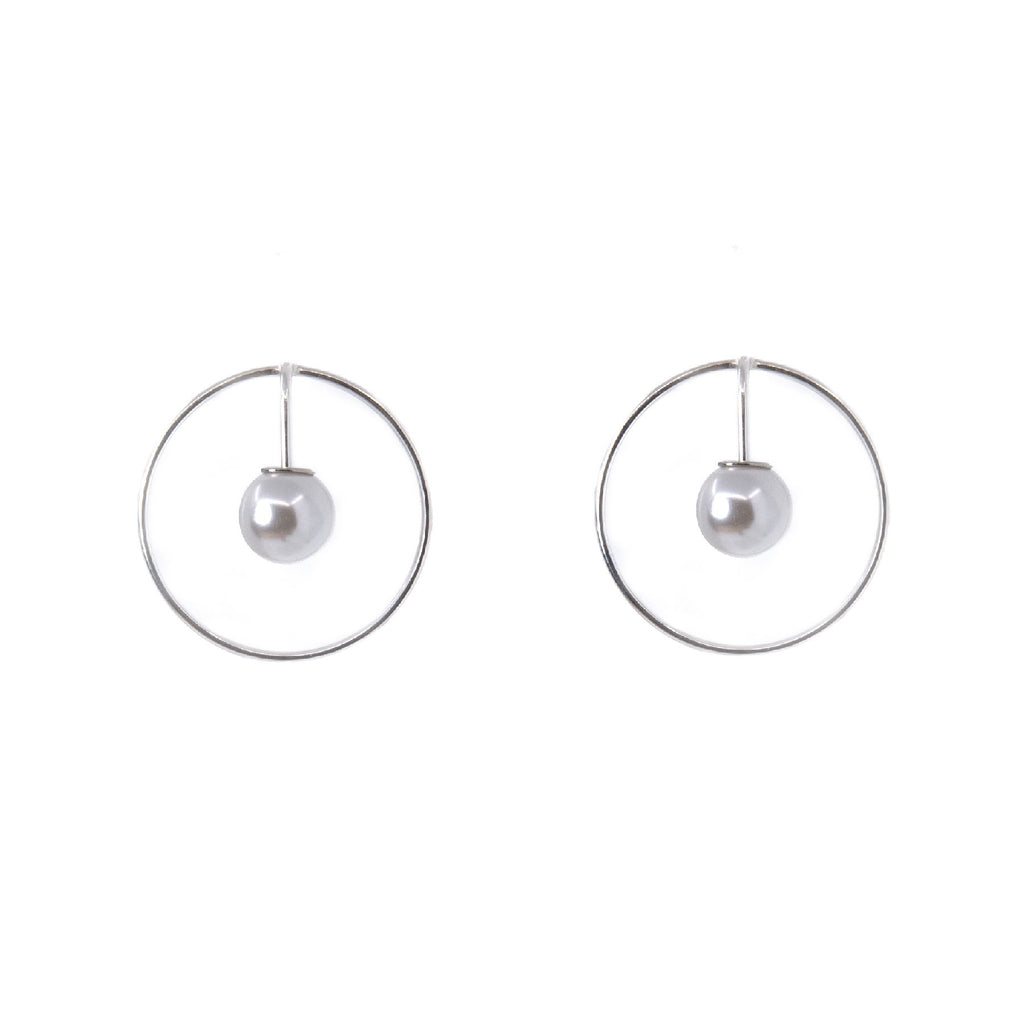 2. Studio image of Maarja Palu SPOT earrings featuring a pearl suspended in a silver circle